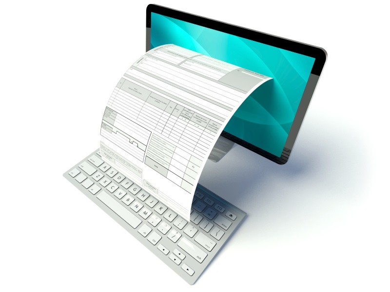 Komputer z klawiaturą oraz dokumentem wyłaniającym się z monitora